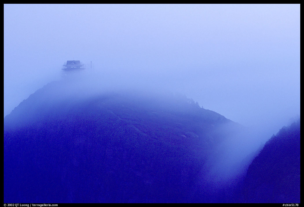 Fog sweaps over Wanfo Ding (Ten Thousand Buddhas Summit) at dusk. Emei Shan, Sichuan, China