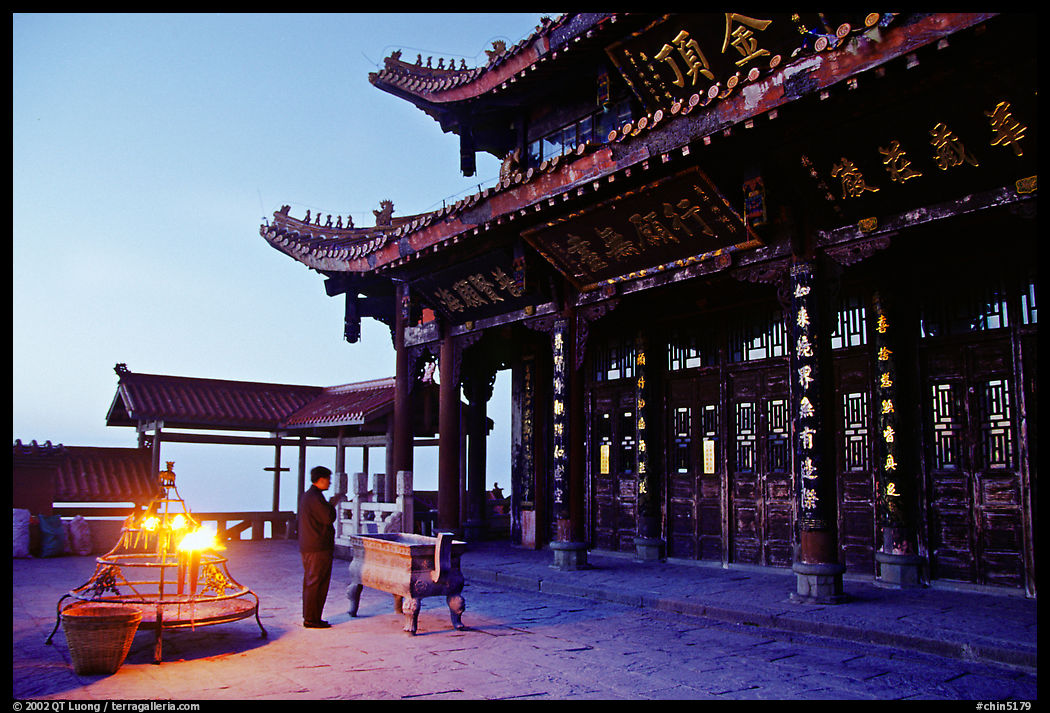 Pilgrim prays in the Jinding Si (Golden Summit) temple at dusk. Emei Shan, Sichuan, China