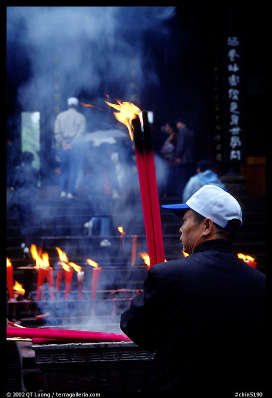 Pilgrim offering big incense stick. Emei Shan, Sichuan, China