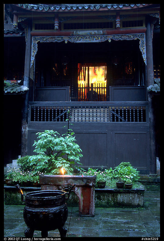 Buddha image seen from rainy courtyard of Hongchunping temple. Emei Shan, Sichuan, China