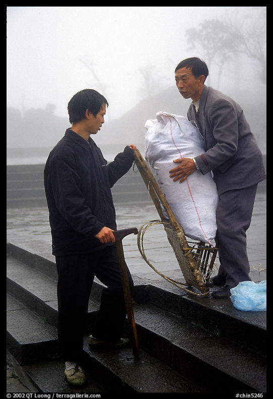 Porter getting ready to carry a heavy load on a back frame. Emei Shan, Sichuan, China