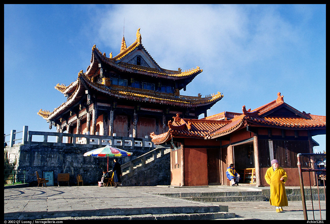 Monk walking in front of Jinding Si temple. Emei Shan, Sichuan, China
