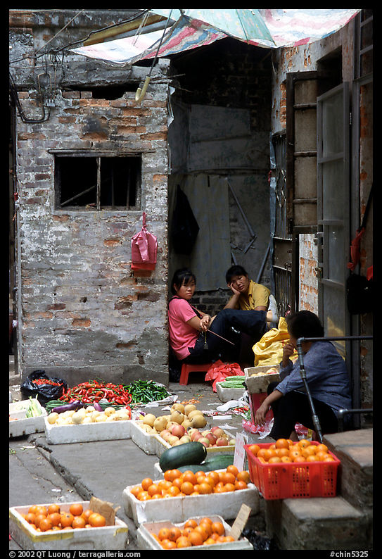 Fruit vendors in a narrow alley. Guangzhou, Guangdong, China