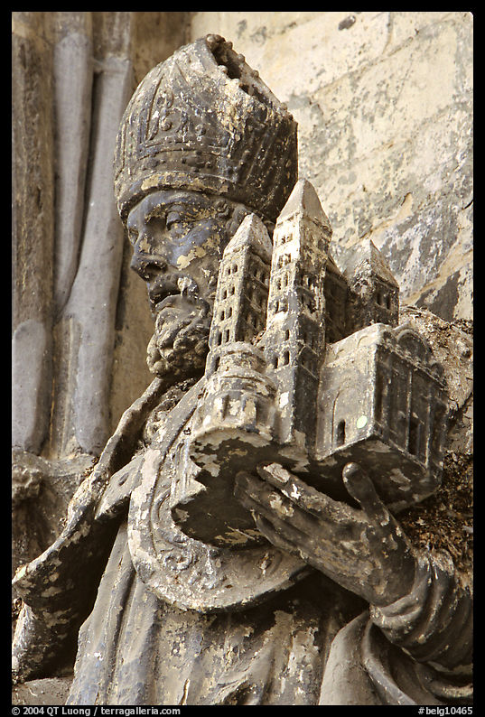 Statue outside of Notre Dame Cathedral showing a model of the cathedral being held. Tournai, Belgium