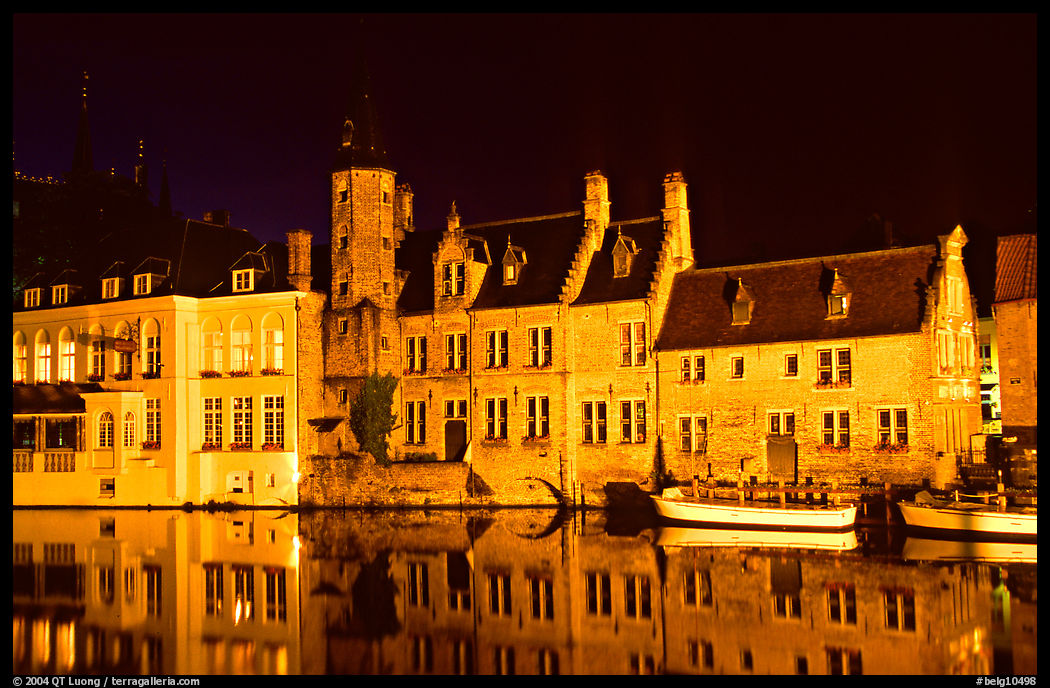 Houses reflected in canal, Rozenhoedkaai, night. Bruges, Belgium