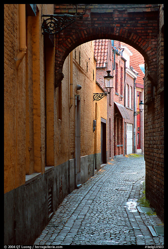 Narrow cobled street and archway. Bruges, Belgium