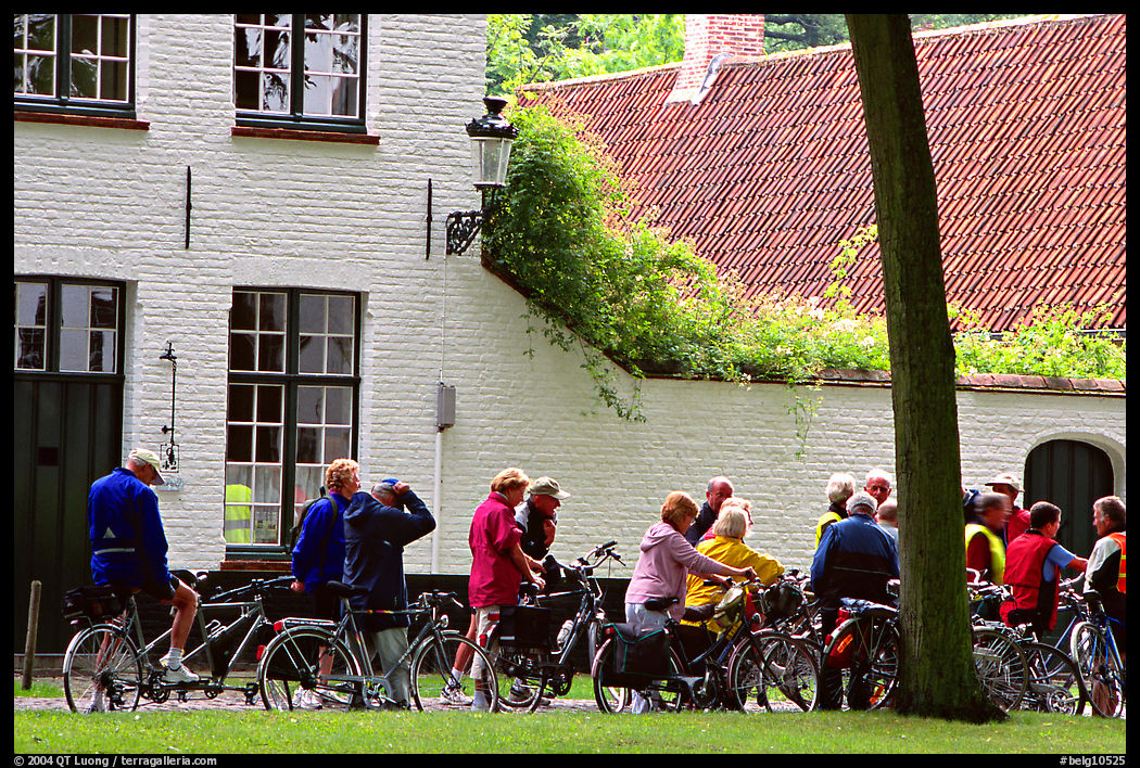 Bicylists in Courtyard of the Begijnhof. Bruges, Belgium