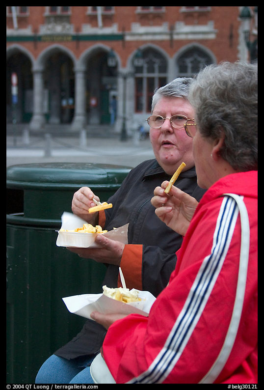 Elderly women eating fries. Bruges, Belgium