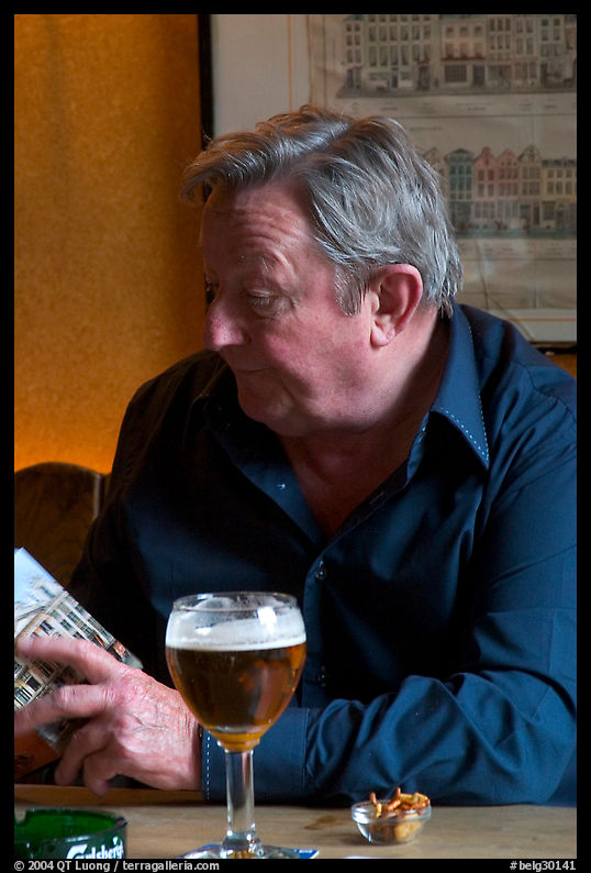 Man with book and beer. Brussels, Belgium
