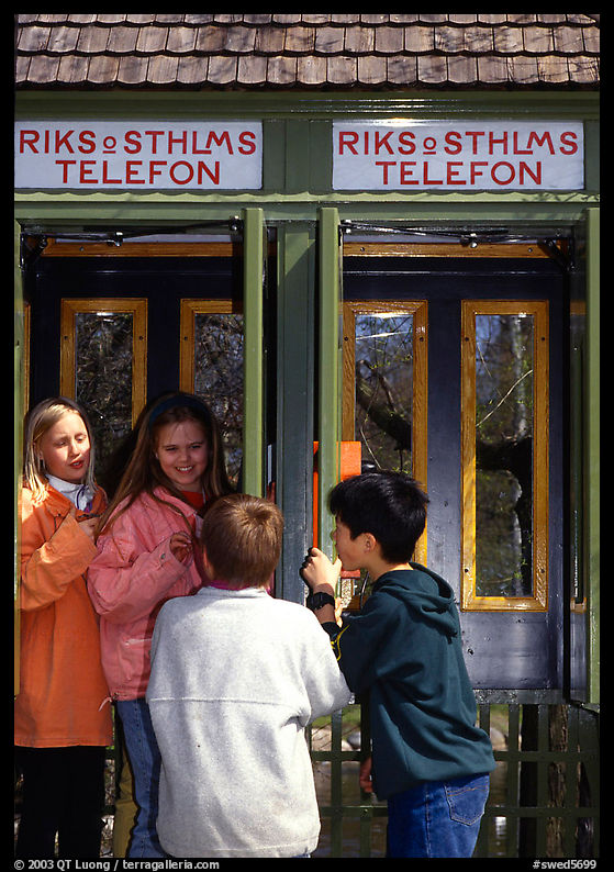Swedish kids in a phone booth. Stockholm, Sweden