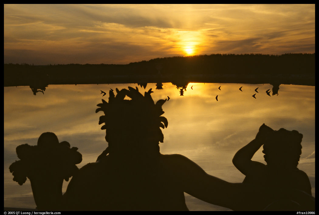 Sunset over a basin in the Versailles palace gardens. France