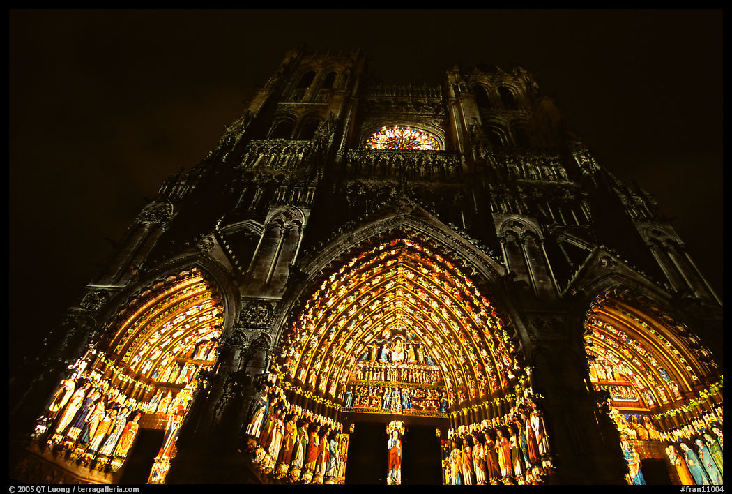 Looking up cathedral with doors laser-illuminated to recreate original colors, Amiens. France