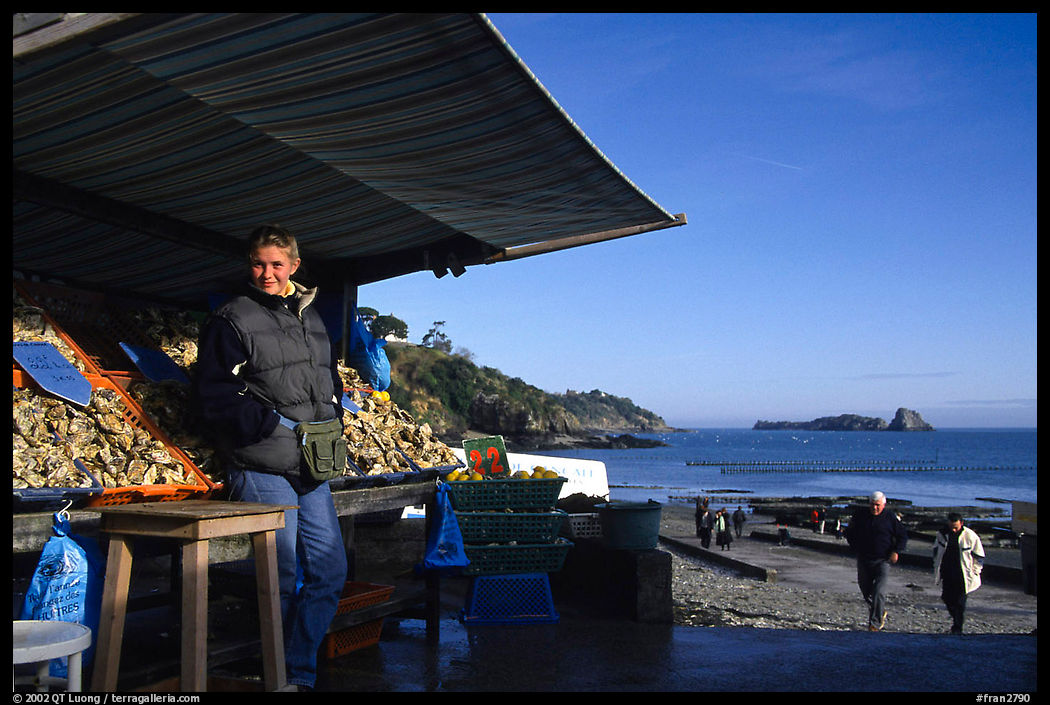 Oyster stand and vendor in Cancale. Cancale oysters are reknown in France. Brittany, France