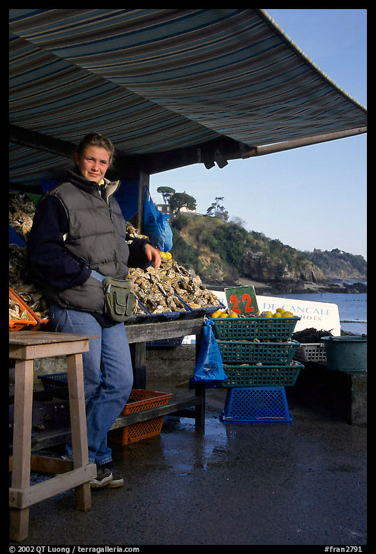 Oyster stand and vendor in Cancale. Brittany, France