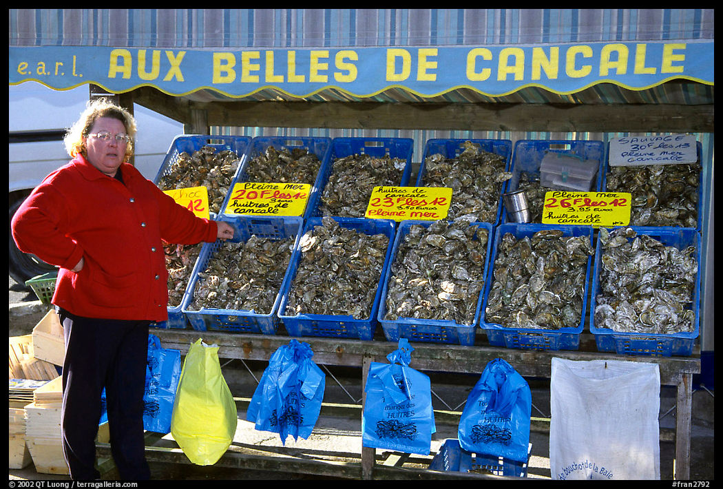 Oyster stand and vendor in Cancale. Brittany, France