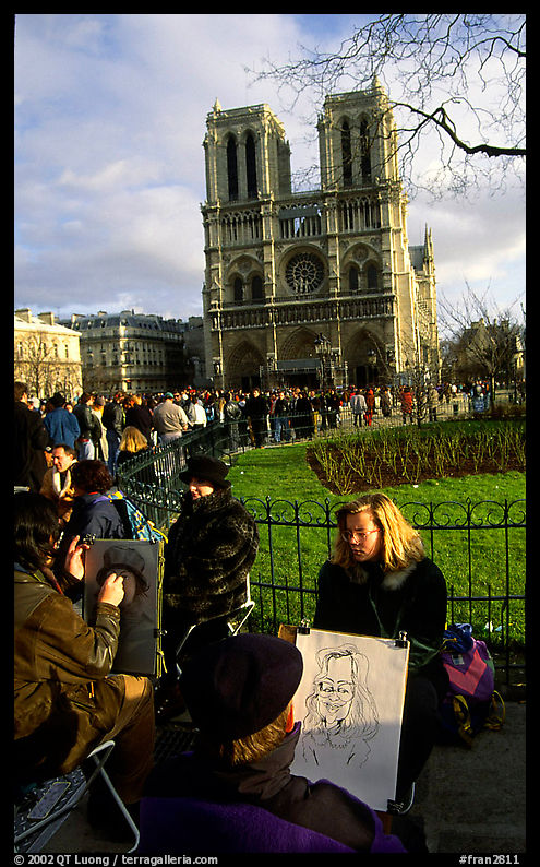 Sketch drawers in front of Notre Dame Cathedral. Paris, France