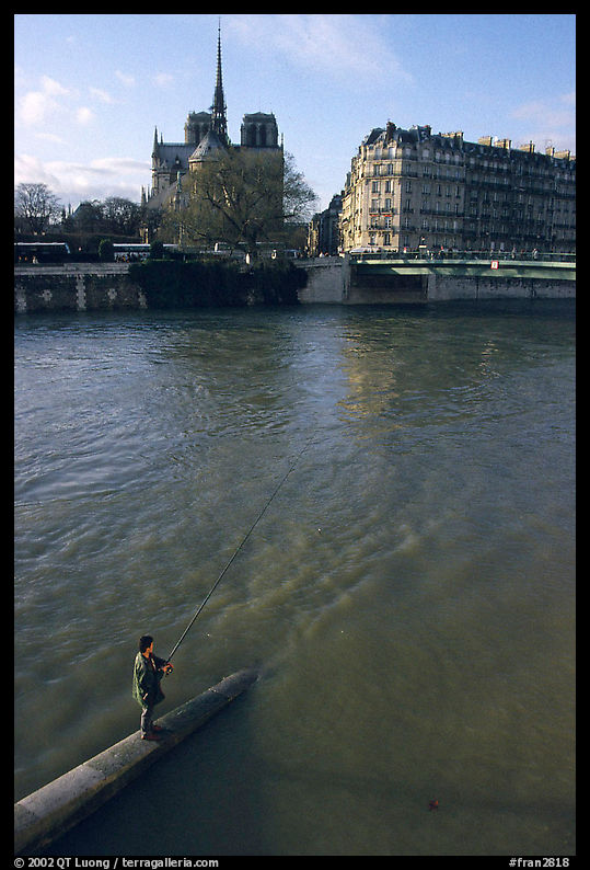Fishing in the Seine river, Notre Dame Cathedral in the background. Paris, France