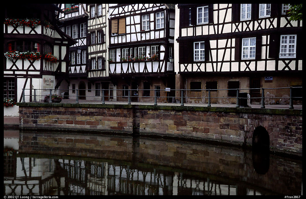 Half-timbered houses reflected in canal. Strasbourg, Alsace, France