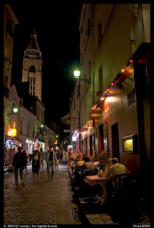 Dinners and narrow pedestrian street at night, Montmartre. Paris, France
