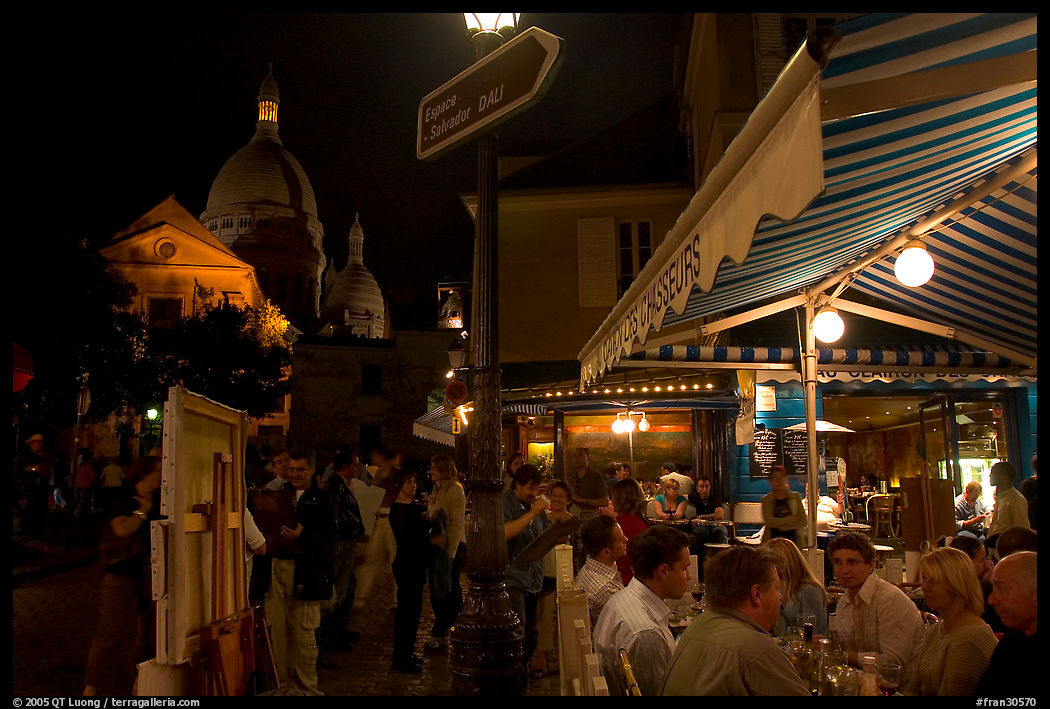 Outdoor dining at night on the Place du Tertre, Montmartre. Paris, France