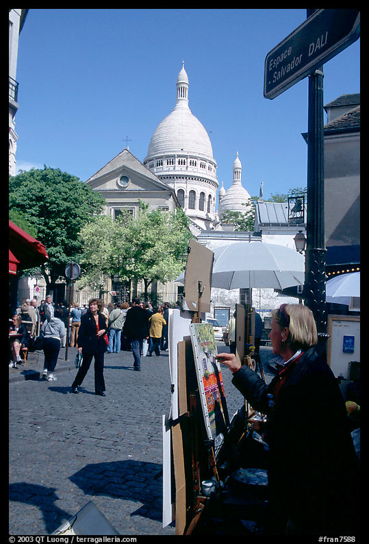 Painter on Place du Tertre, with the Sacre Coeur in the background, Montmartre. Paris, France