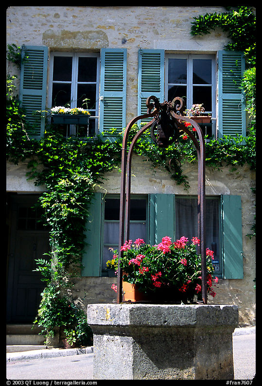 Flowers on a well, old  Vezelay. Burgundy, France