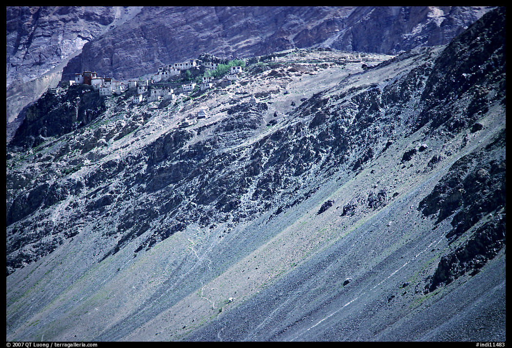Rocky slopes topped by village and gompa, Zanskar, Jammu and Kashmir. India