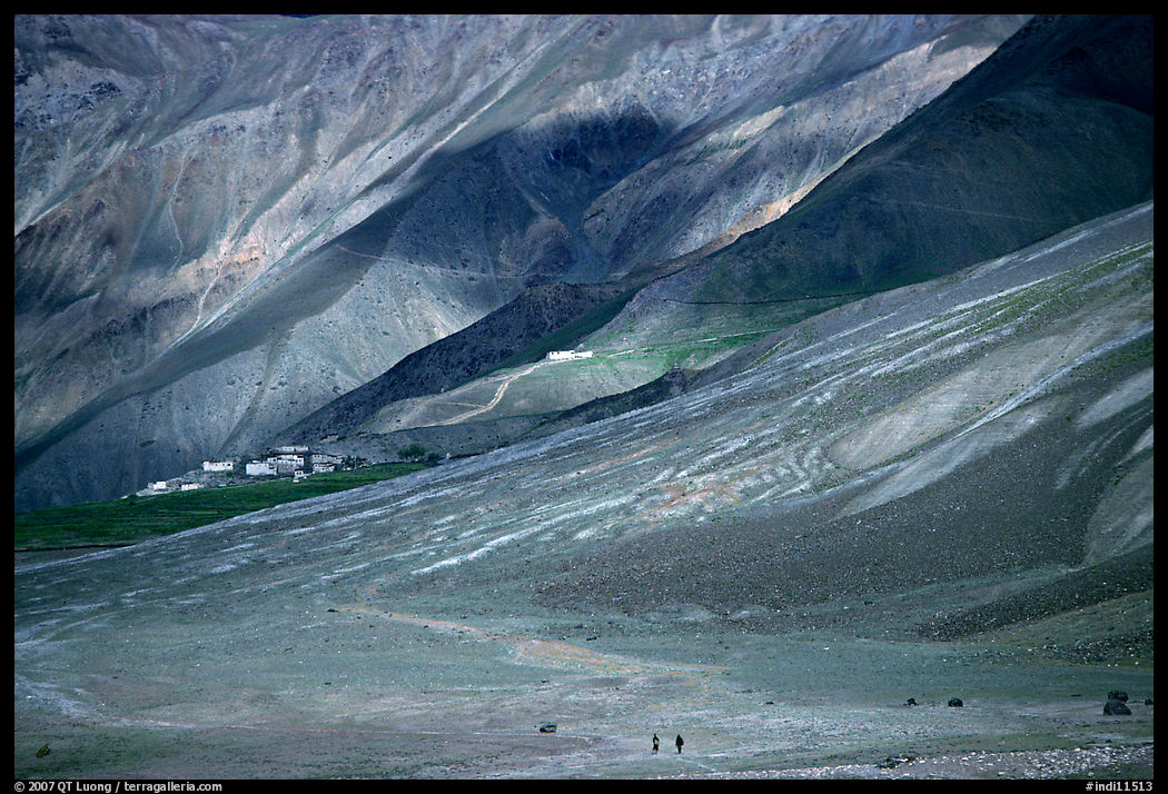 Barren hills with figures walking towards Karsha monastery, Zanskar, Jammu and Kashmir. India