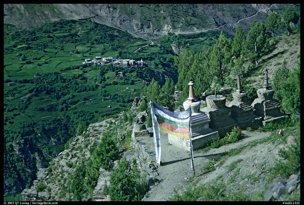 Prayer flag, chortens, and verdant valley below, Himachal Pradesh. India