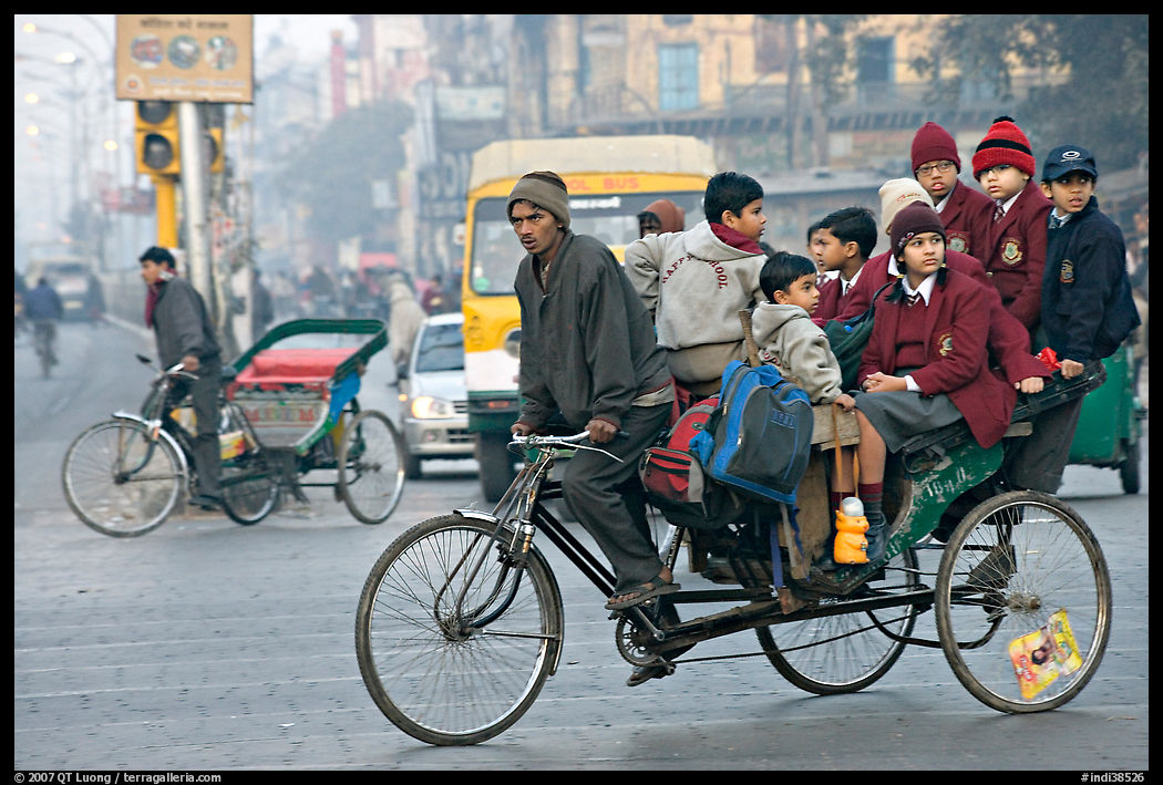 Cycle-rickshaw with a load of ten schoolchildren. New Delhi, India