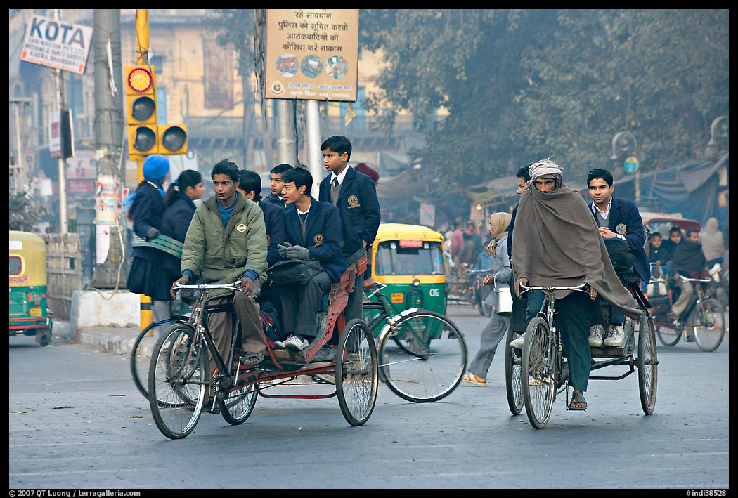 Cycle-rickshaws carrying uniformed schoolchildren. New Delhi, India