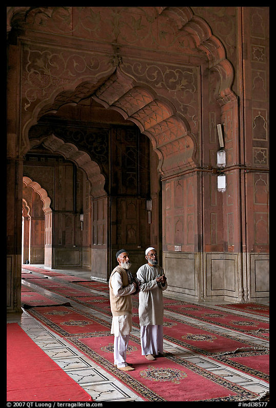 Two muslem men in Jama Masjid mosque prayer hall. New Delhi, India