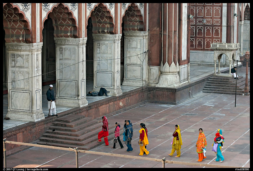 Women in colorful sari walking towards prayer hall, Jama Masjid. New Delhi, India