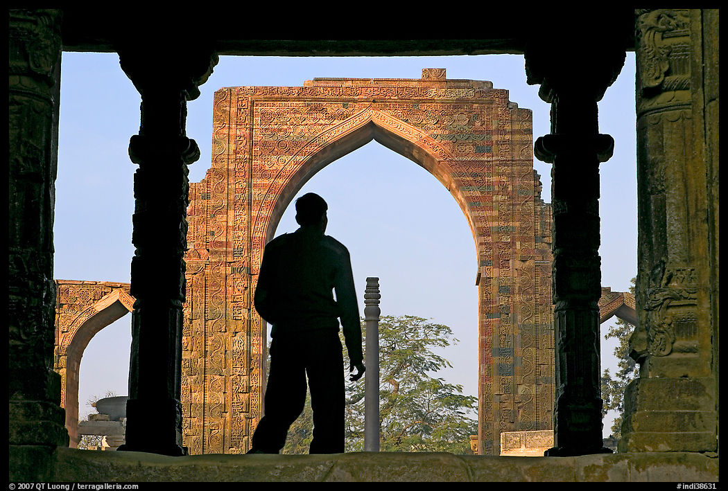 Man at entrance of ruined Quwwat-ul-Islam mosque. New Delhi, India