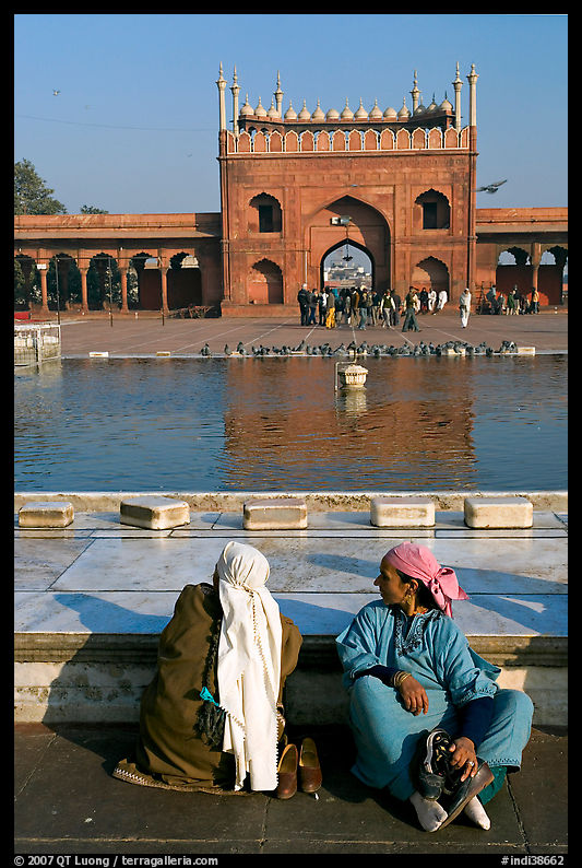 Women sitting near basin in courtyard of Jama Masjid. New Delhi, India