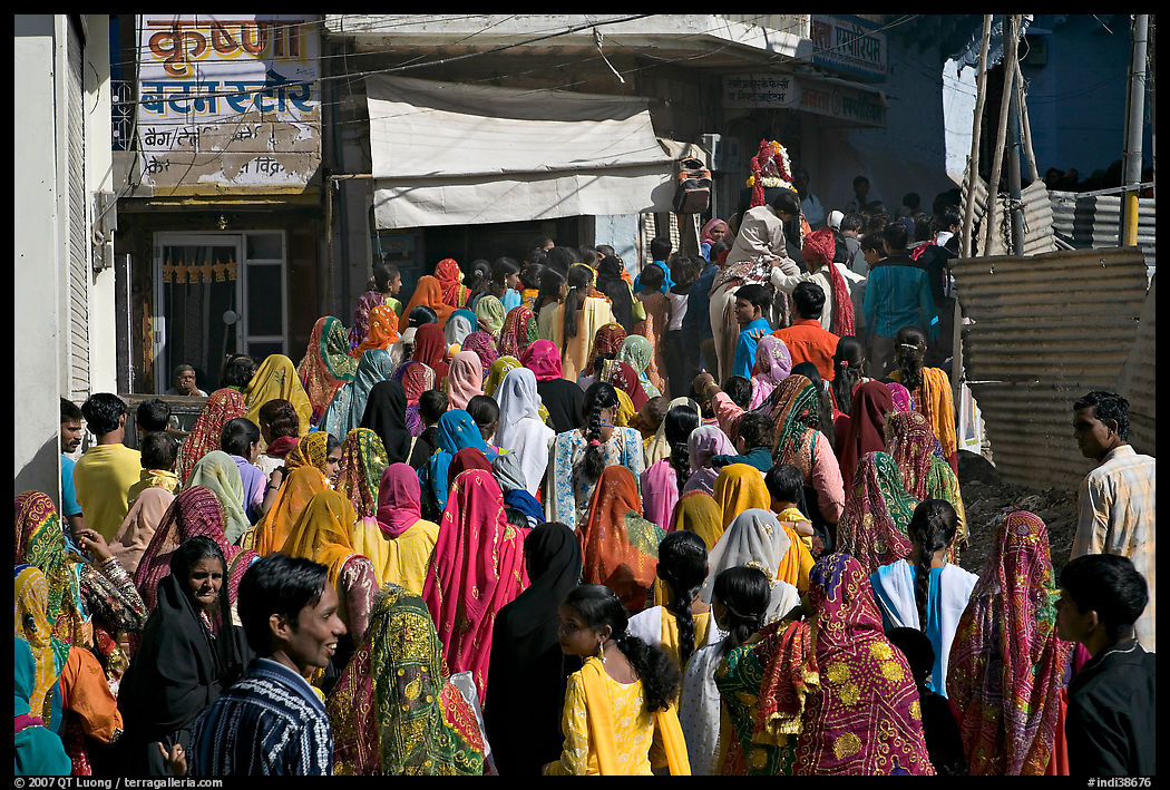 Street with women in colorful sari following wedding procession. Jodhpur, Rajasthan, India