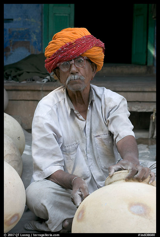Man with turban holding a jar. Jodhpur, Rajasthan, India