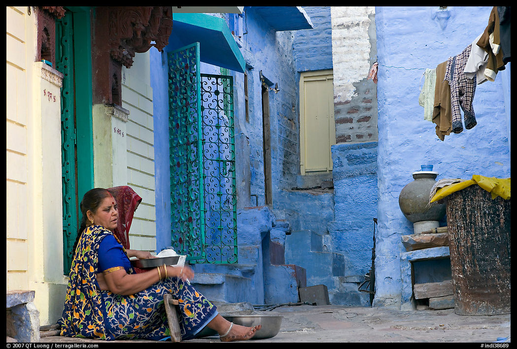 Women sitting in alley painted with indigo tinge. Jodhpur, Rajasthan, India