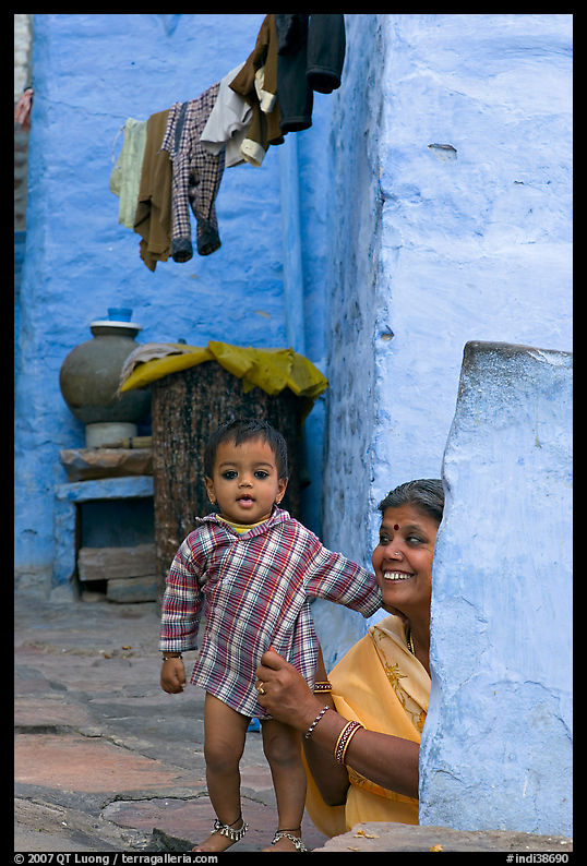 Baby girl and woman in blue alley. Jodhpur, Rajasthan, India