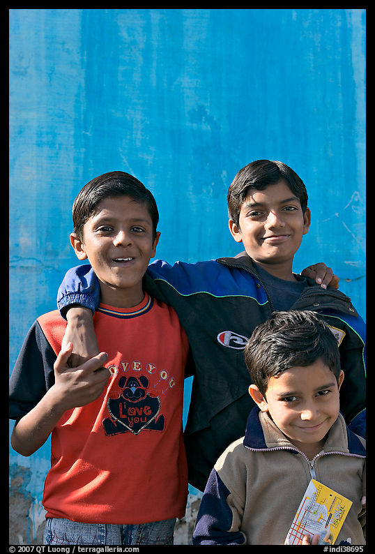 Young boys in front of blue wall. Jodhpur, Rajasthan, India
