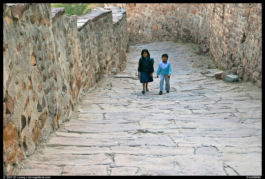 Children walking on the stone ramp leading to the fort. Jodhpur, Rajasthan, India