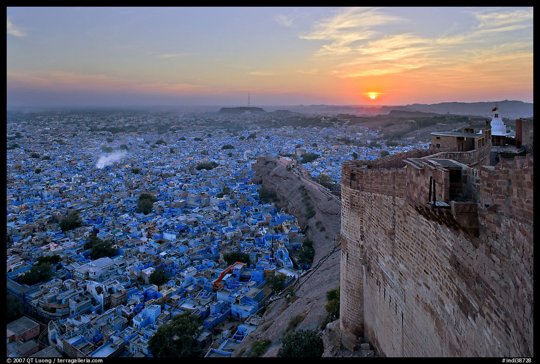 Mehrangarh Fort walls, blue houses, and setting sun. Jodhpur, Rajasthan, India