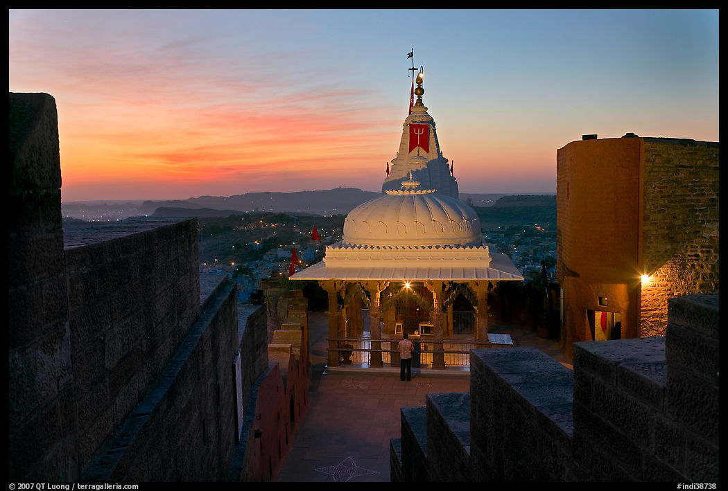 Chamunda Devi temple with man worshipping at sunset, Mehrangarh Fort. Jodhpur, Rajasthan, India