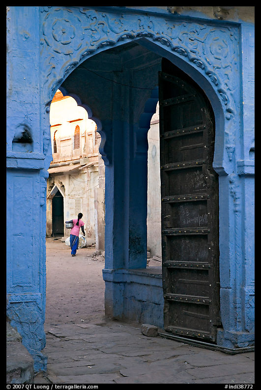 Archway with woman carrying water in courtyard. Jodhpur, Rajasthan, India