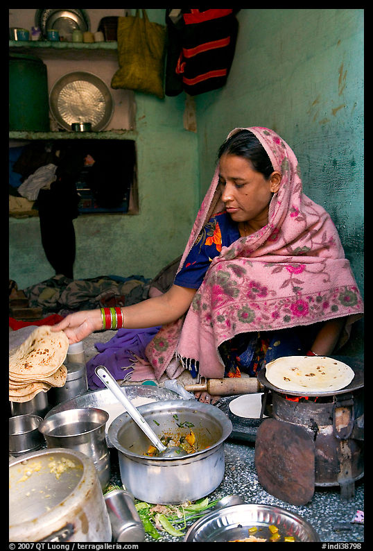 Woman with headscarf stacking chapati bread. Jodhpur, Rajasthan, India