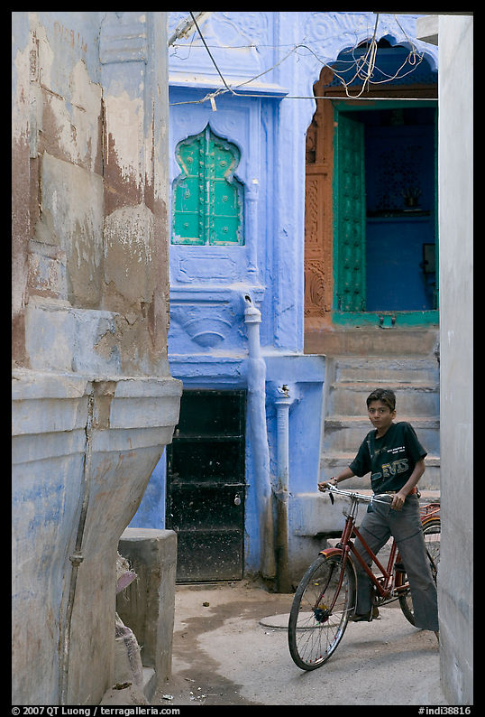 Boy riding a bicycle in a narrow old town street. Jodhpur, Rajasthan, India