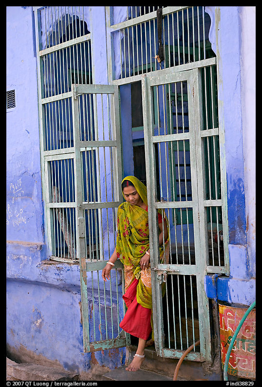 Woman stepping out of door. Jodhpur, Rajasthan, India