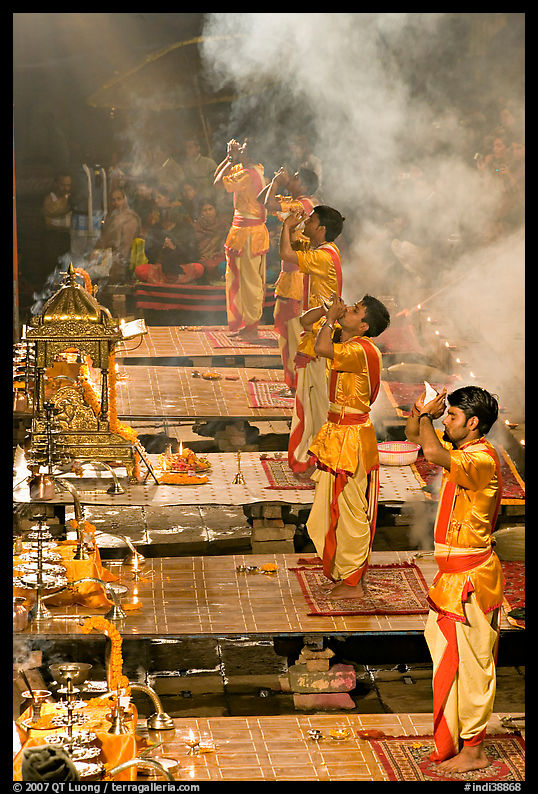Young priests open Puja ceremony by blowing a conch-shell. Varanasi, Uttar Pradesh, India