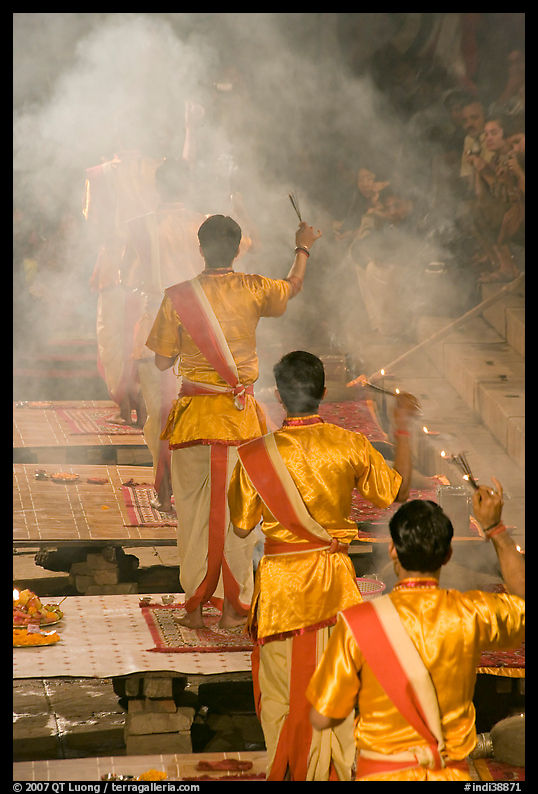 Brahmans standing amongst clouds of incense during puja. Varanasi, Uttar Pradesh, India