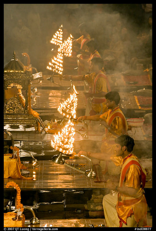 Holy men lifting chandeliers during evening puja. Varanasi, Uttar Pradesh, India